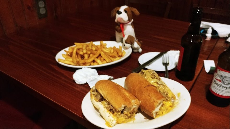 Charlie Checking Out the Chesesteak and Fries